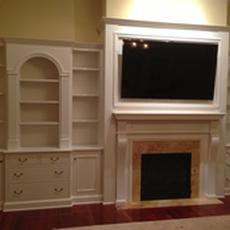 Office Cabinetry - A painted fireplace wall unit with space for TV, books, and storage.